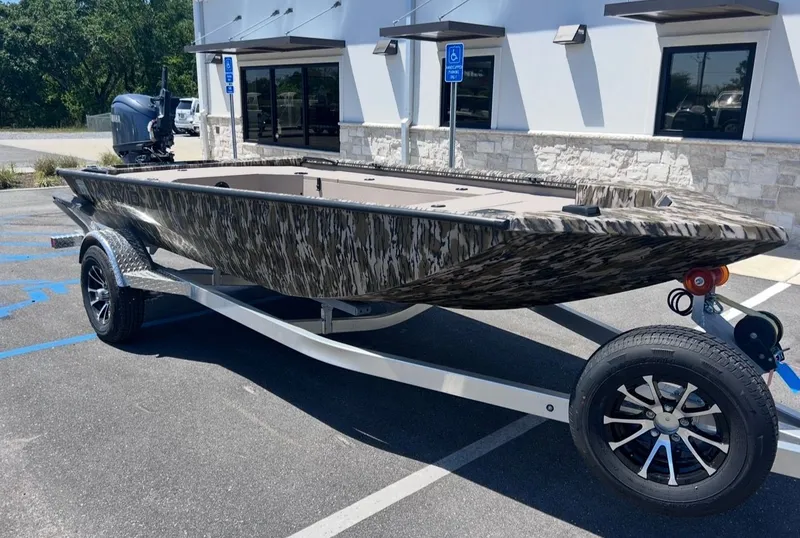 Slide: The Image of Avid 16 Commander 2026 boat on trailer outside building. - 7