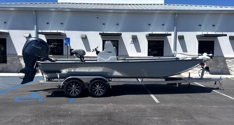 The Image of Avid 22 Recon boat 2026 on trailer in front of building. - 1