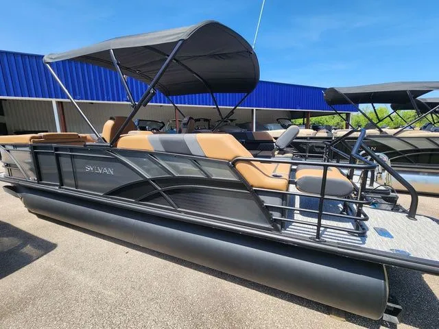 Slide: The Image of 2026 Sylvan L-3 LZ DH pontoon boat with canopy, displayed in parking lot. - 8