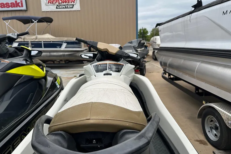 Slide: The Image of 2012 Seadoo GTX-IS-LTD jet ski parked at a dealership, surrounded by other watercraft. - 5