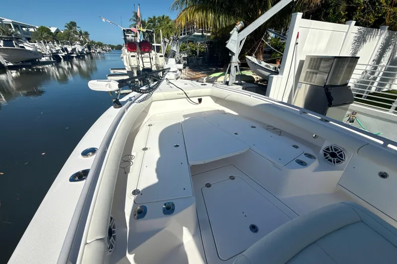 Slide: The Image of 2021 Everglades 273 Center Console boat docked in a serene marina setting. - 11