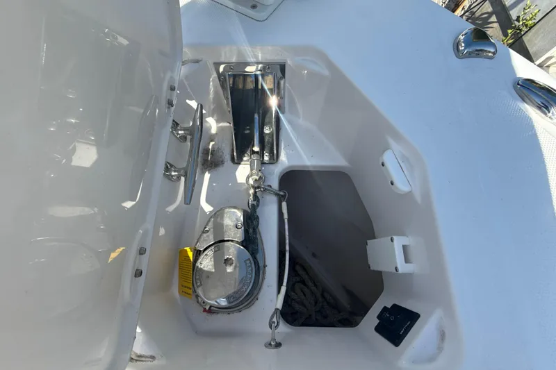 Slide: The Image of Anchor compartment of 2021 Everglades 273 Center Console boat, featuring winch and storage. - 15