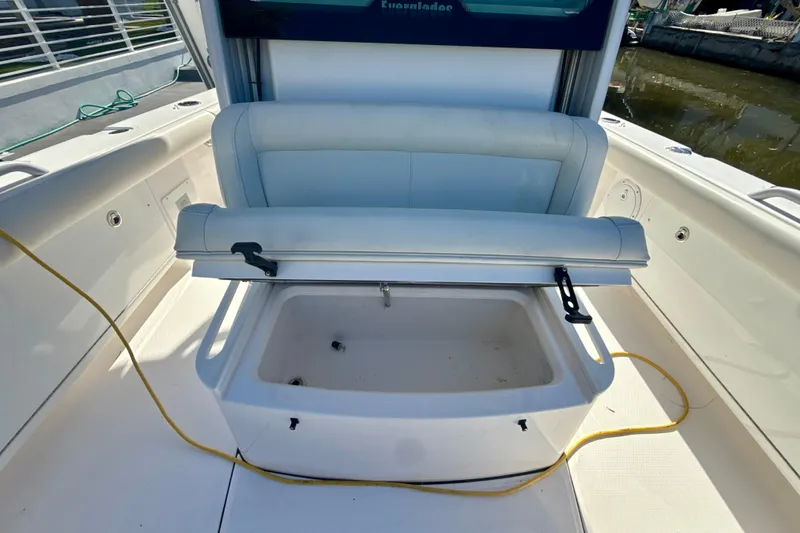 Slide: The Image of 2021 Everglades 273 Center Console boat with open storage compartment on deck. - 17