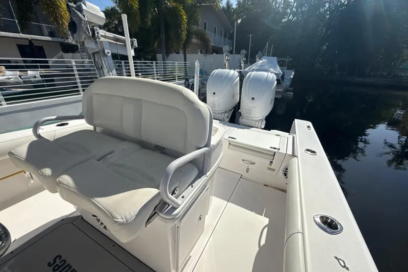 Slide: The Image of 2021 Everglades 273 Center Console boat with dual engines docked by the water. - 19