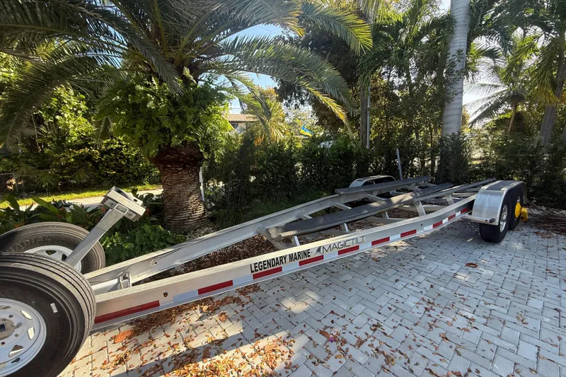 Slide: The Image of Trailer for 2021 Everglades 273 Center Console, parked on a paved driveway surrounded by palm trees. - 24