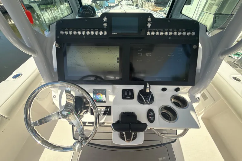 Slide: The Image of Cockpit of 2021 Everglades 273 Center Console boat with advanced navigation controls. - 8
