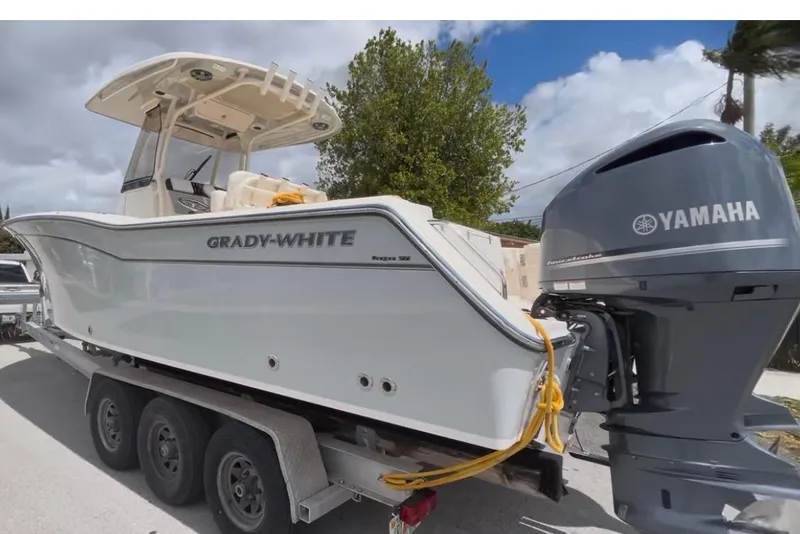 Slide: The Image of 2021 Grady-White Canyon 271 FS boat on trailer with Yamaha outboard motor. - 1