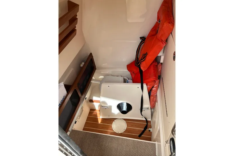 Slide: The Image of Interior of 2021 Grady-White Canyon 271 FS boat with life jackets and storage. - 12