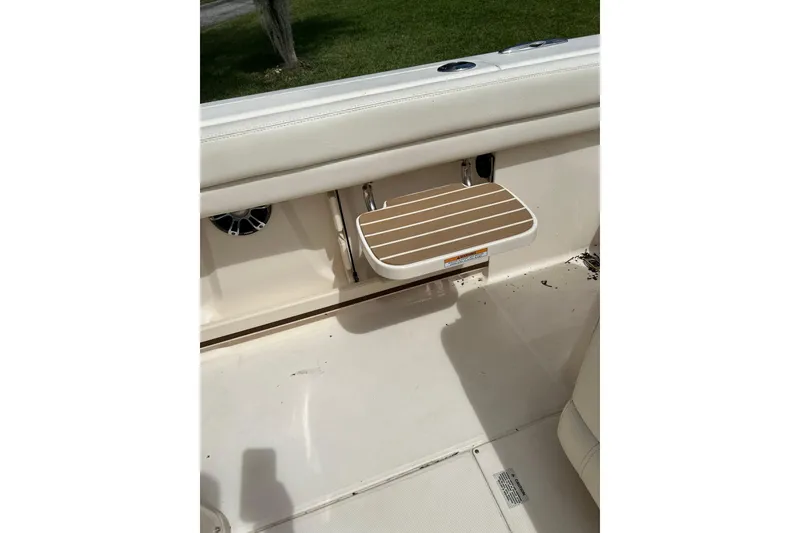 Slide: The Image of 2021 Grady-White Canyon 271 FS boat interior with foldable seat and clean deck. - 14