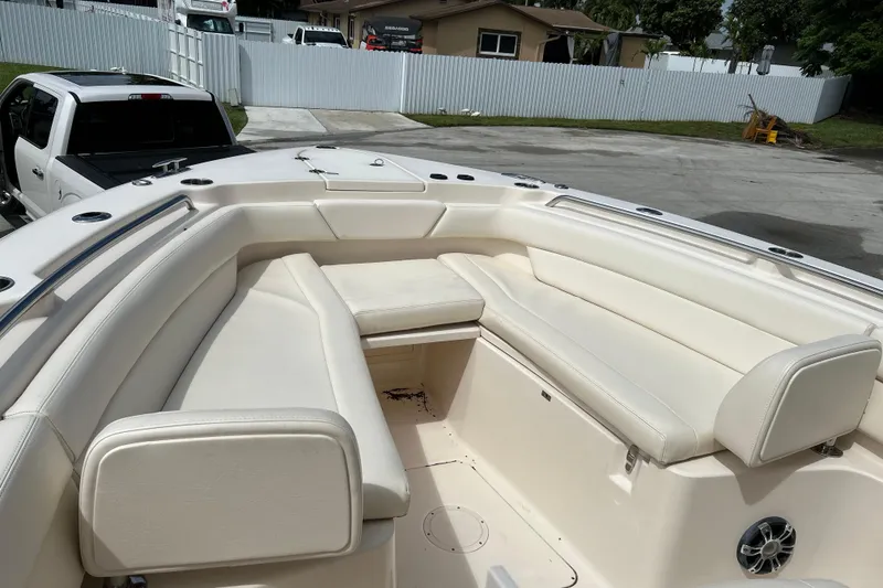 Slide: The Image of 2021 Grady-White Canyon 271 FS boat with spacious seating in a driveway setting. - 15