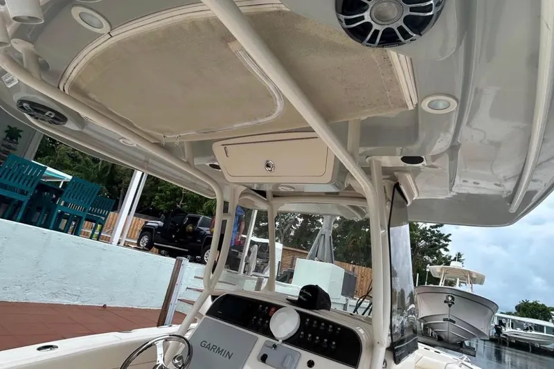 Slide: The Image of 2021 Grady-White Canyon 271 FS boat interior with Garmin navigation system and speakers. - 16