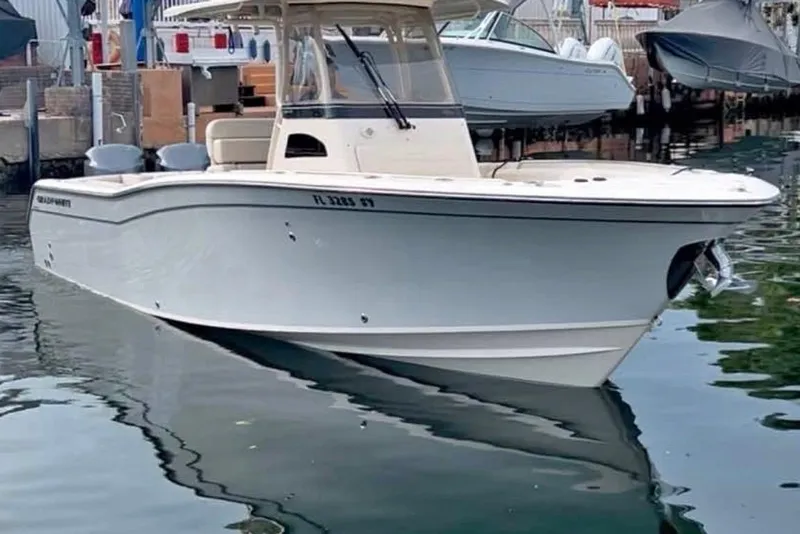 Slide: The Image of 2021 Grady-White Canyon 271 FS boat docked in marina, side view. - 2