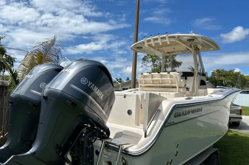 Slide: The Image of 2021 Grady-White Canyon 271 FS boat with dual Yamaha engines, parked outdoors. - 3