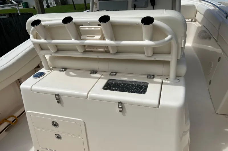 Slide: The Image of 2021 Grady-White Canyon 271 FS boat interior with rod holders and storage compartments. - 6