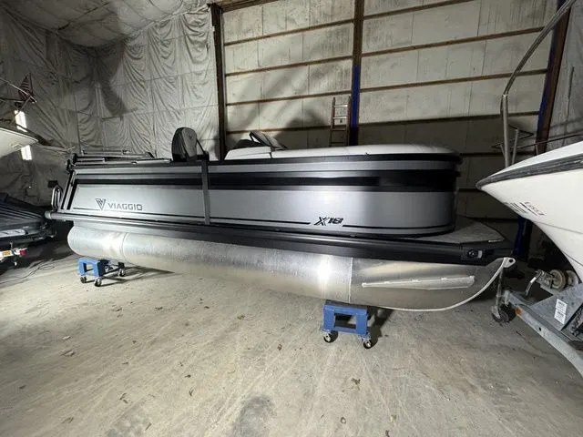 The Image of Viaggio X18U Bi-Toon 2026 pontoon boat stored indoors. - 1