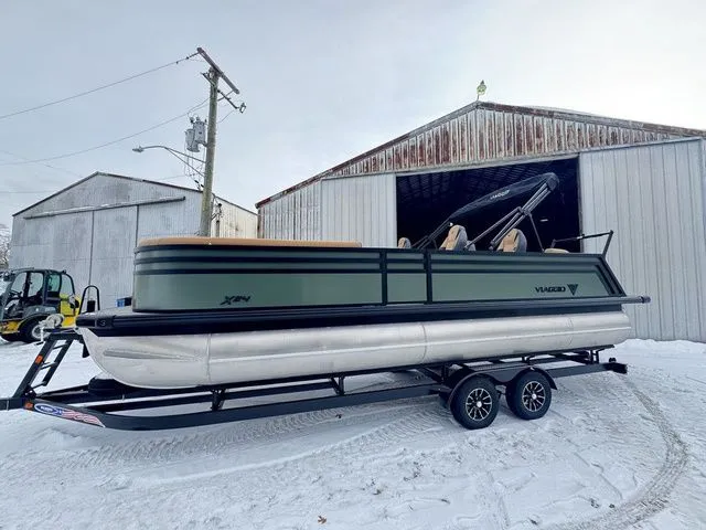The Image of 2026 Viaggio X24Q Tri-Toon boat outside warehouse in snow. - 1