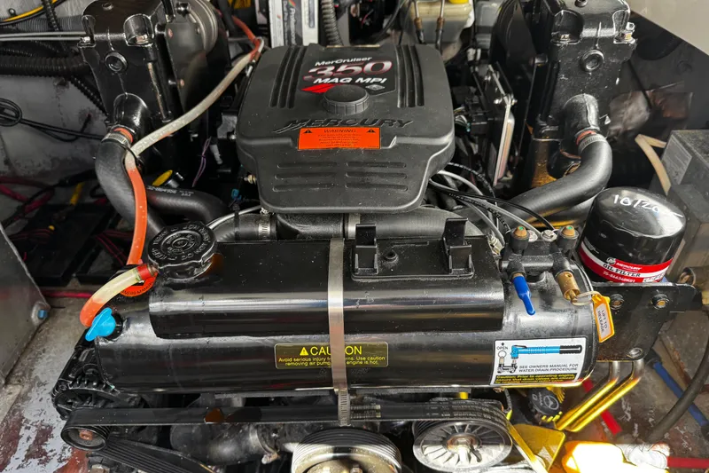 Slide: The Image of 2004 Crownline 250 CR boat interior with white leather seating and sleek design. - 100