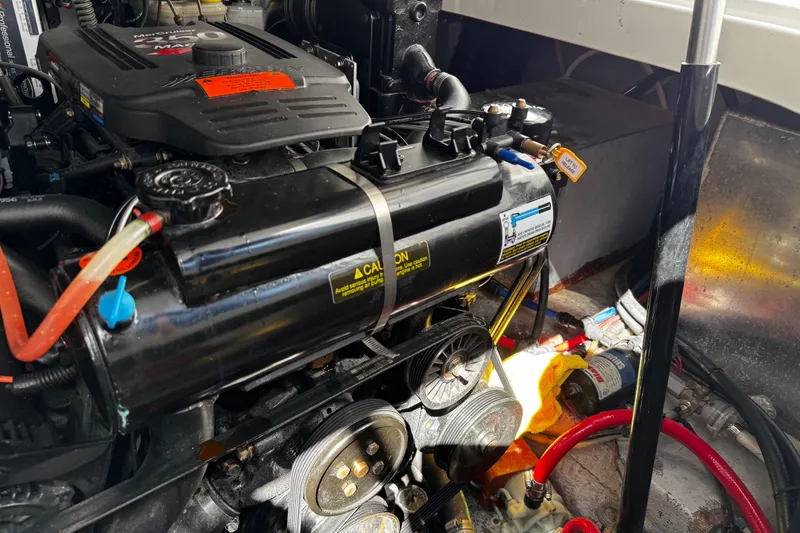 Slide: The Image of Engine compartment of a 2004 Crownline 250 CR boat, showcasing mechanical components. - 109