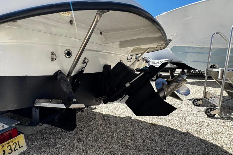 Slide: The Image of 2004 Crownline 250 CR boat with black canopy in a marina setting. - 11