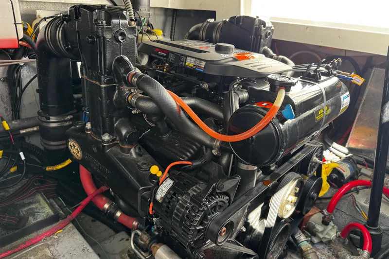 Slide: The Image of Engine of a 2004 Crownline 250 CR boat, showcasing detailed mechanical components. - 110