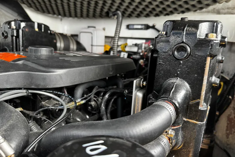 Slide: The Image of Engine compartment of a 2004 Crownline 250 CR boat, showcasing detailed mechanical components. - 112
