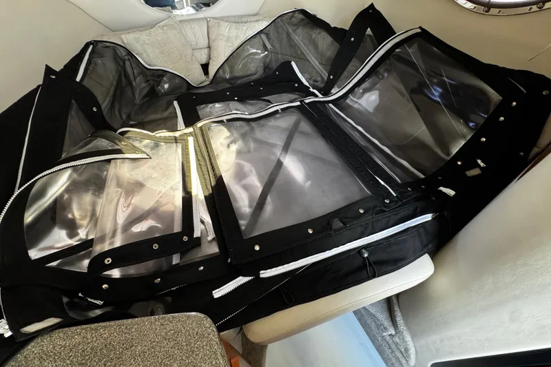 Slide: The Image of 2004 Crownline 250 CR boat stern with propeller and outdrive, parked on gravel. - 18