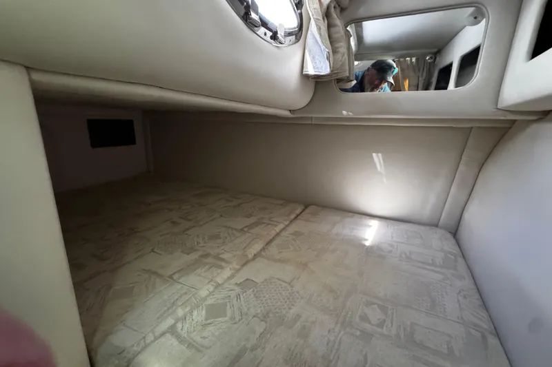 Slide: The Image of 2004 Crownline 250 CR boat on trailer, parked outdoors under clear blue sky. - 23