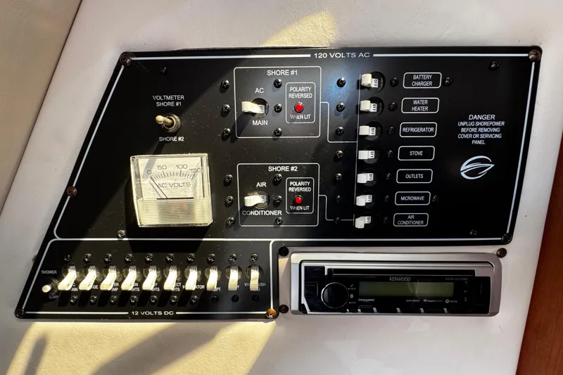 Slide: The Image of 2004 Crownline 250 CR boat with black cover in a marina setting. - 24