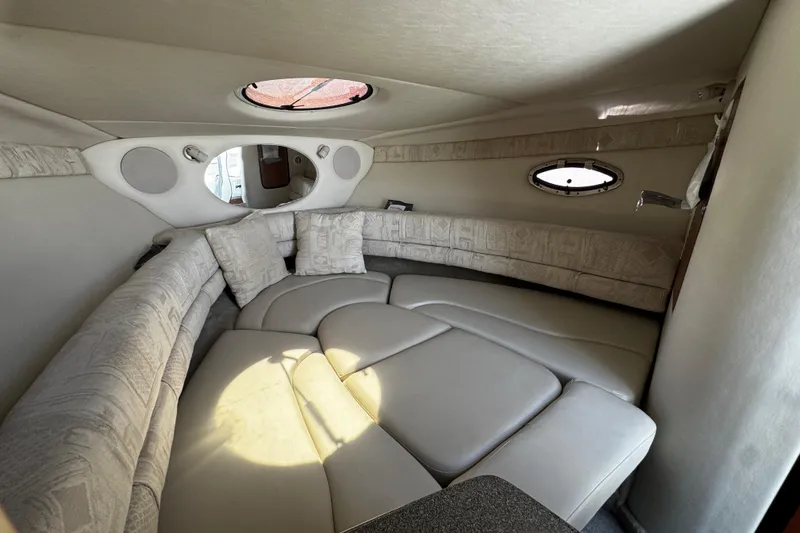 Slide: The Image of 2004 Crownline 250 CR cabin interior with cozy sleeping area and soft lighting. - 28