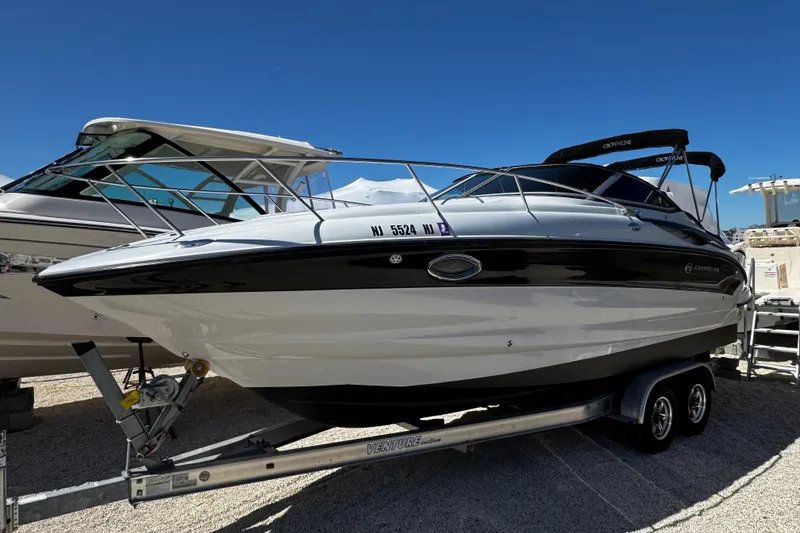 Slide: The Image of 2004 Crownline 250 CR boat on trailer under clear blue sky. - 3
