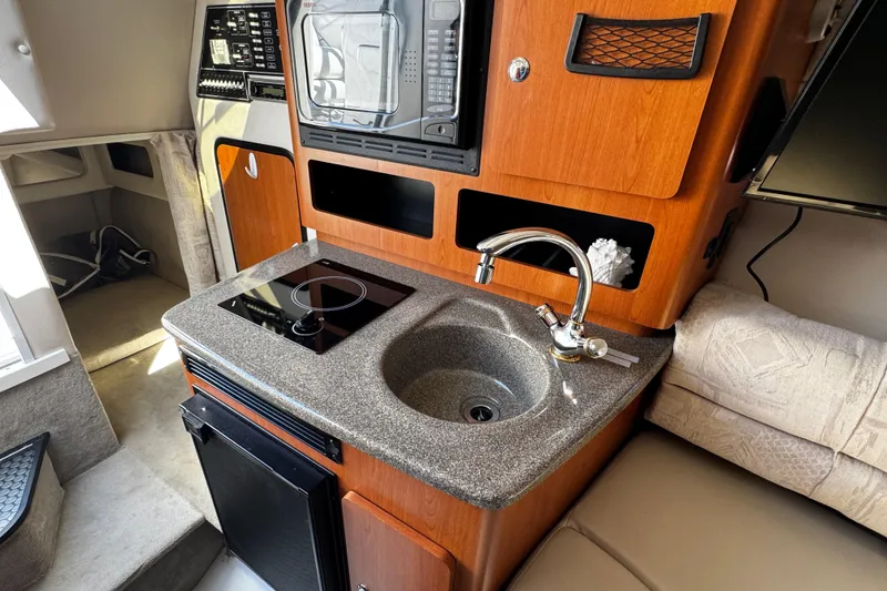 Slide: The Image of Compact bathroom in 2004 Crownline 250 CR boat with sink and toilet. - 40