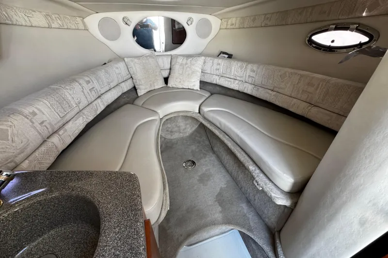 Slide: The Image of 2004 Crownline 250 CR boat bathroom with sink, mirror, and porthole window. - 41