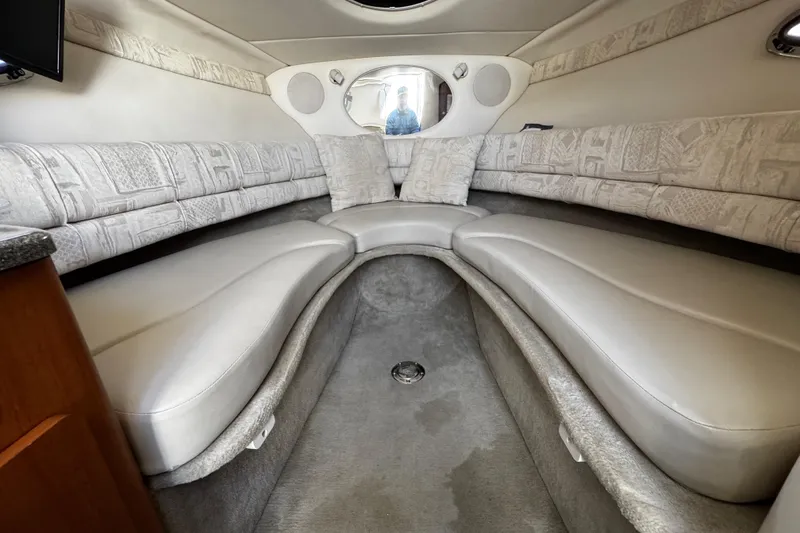 Slide: The Image of 2004 Crownline 250 CR boat interior with kitchenette, microwave, sink, and seating area. - 42