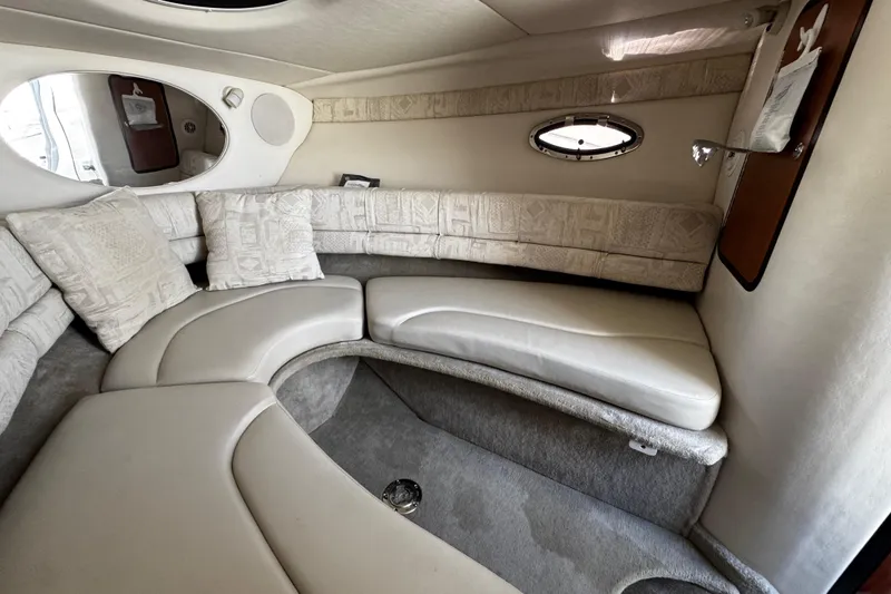 Slide: The Image of 2004 Crownline 250 CR cabin interior with compact fridge and wooden cabinetry. - 43