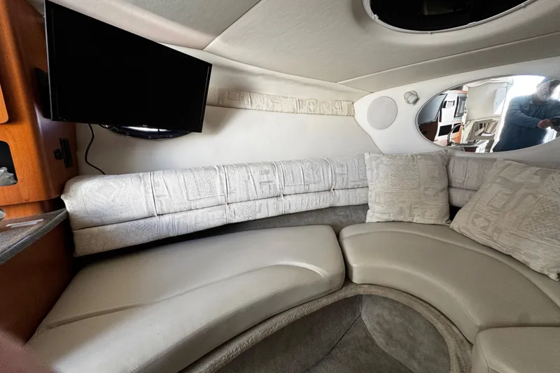 Slide: The Image of Open refrigerator inside 2004 Crownline 250 CR boat cabin, showcasing interior storage space. - 44