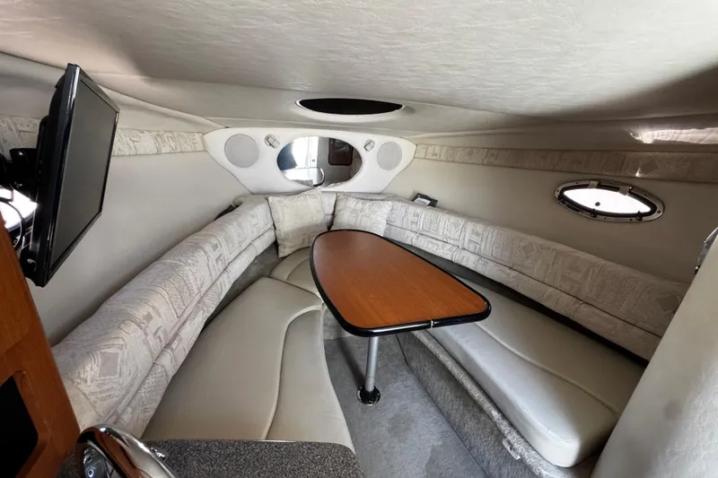 Slide: The Image of 2004 Crownline 250 CR cabin interior with plush seating and compact design. - 48