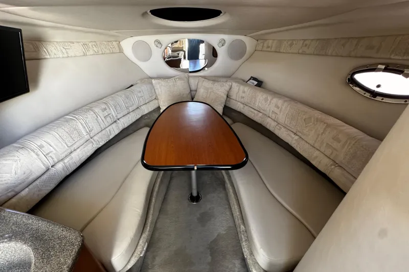 Slide: The Image of Interior of a 2004 Crownline 250 CR boat, featuring plush seating and elegant design. - 49
