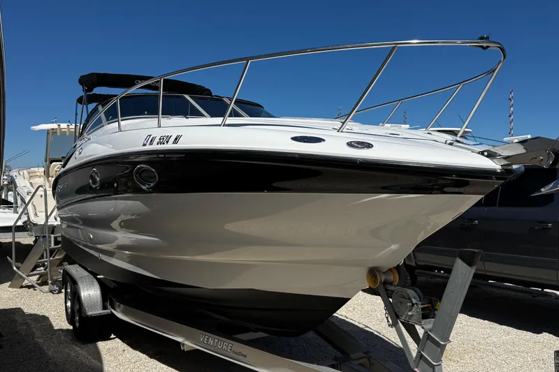 Slide: The Image of 2004 Crownline 250 CR boat on trailer under clear blue sky. - 5