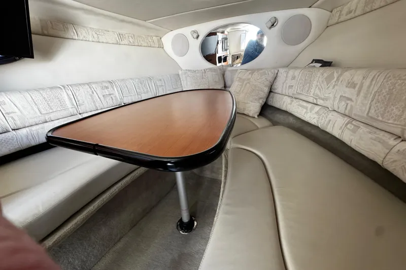 Slide: The Image of Interior of 2004 Crownline 250 CR boat with cozy seating and mounted TV. - 51