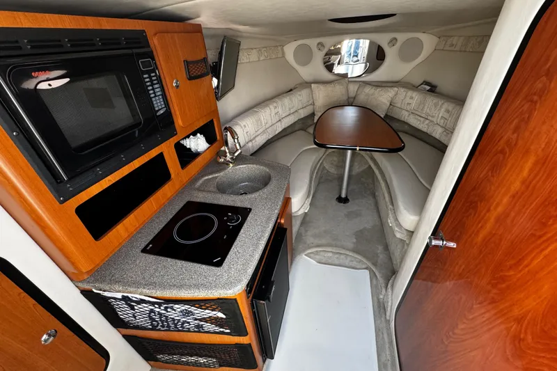 Slide: The Image of Interior of 2004 Crownline 250 CR boat, featuring cozy seating and elegant design. - 52