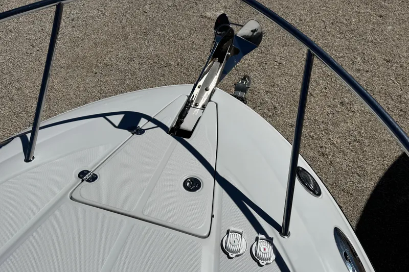 Slide: The Image of Interior of a 2004 Crownline 250 CR boat with cozy seating and a wooden table. - 55