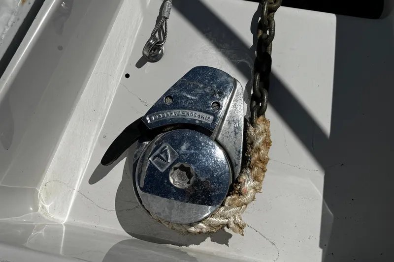 Slide: The Image of 2004 Crownline 250 CR cabin interior with cozy seating and wooden table. - 56