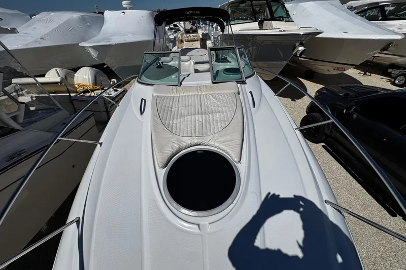 Slide: The Image of Interior of a 2004 Crownline 250 CR boat with a cozy seating area and table. - 58