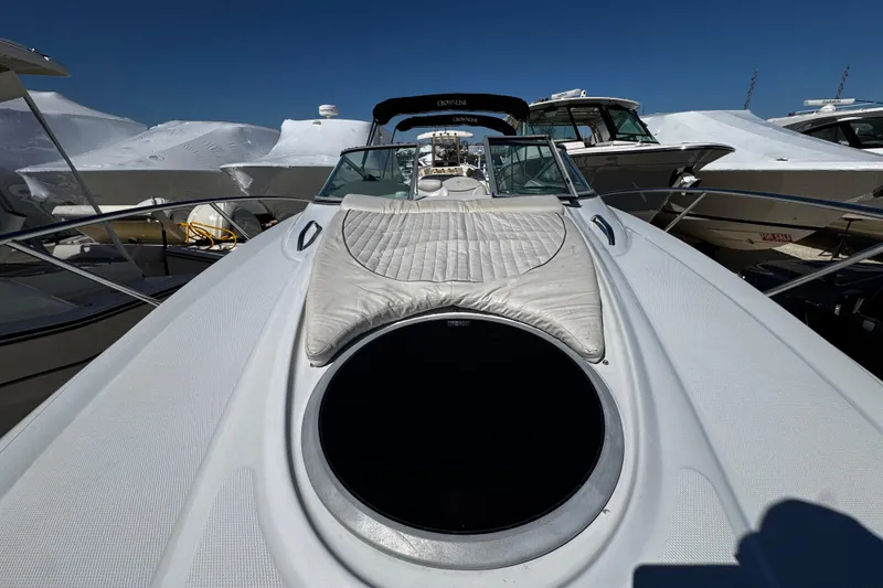 Slide: The Image of 2004 Crownline 250 CR cabin interior with kitchenette, seating area, and modern amenities. - 59