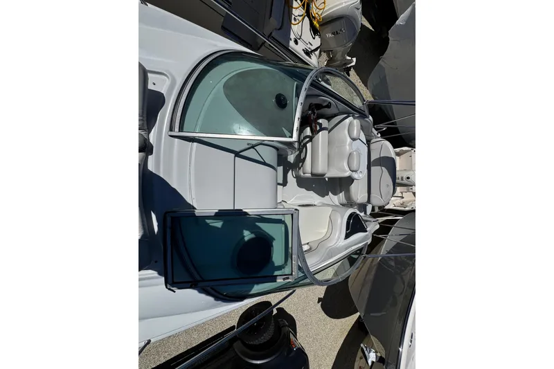 Slide: The Image of Interior of a 2004 Crownline 250 CR boat with cozy seating and table. - 61