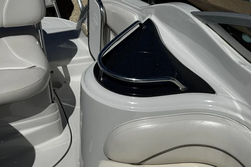 Slide: The Image of 2004 Crownline 250 CR boat with sunpad, docked among other vessels under clear blue sky. - 66