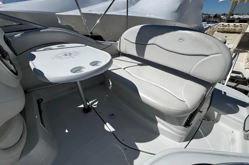 Slide: The Image of 2004 Crownline 250 CR boat with sleek design and spacious deck layout. - 67