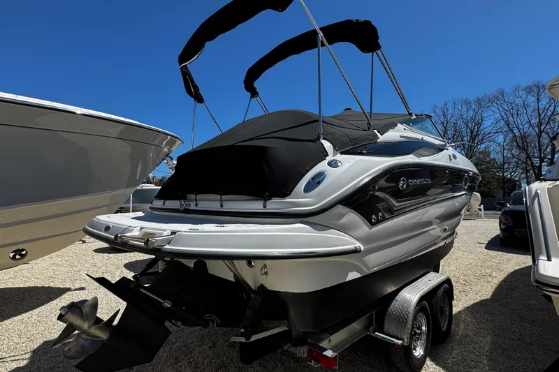 Slide: The Image of 2004 Crownline 250 CR boat with black canopy and visible registration number. - 7