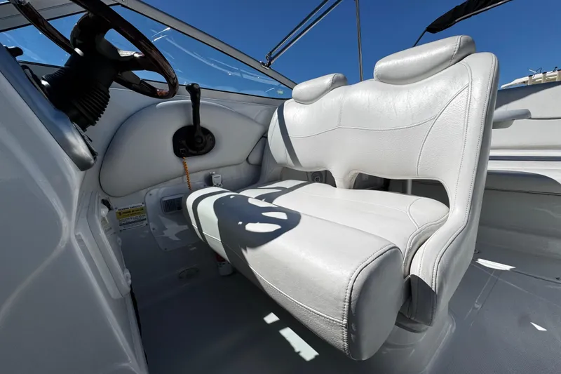 Slide: The Image of Captain's seat and steering wheel of 2004 Crownline 250 CR boat, featuring Garmin navigation. - 70