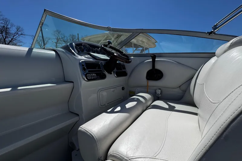 Slide: The Image of 2004 Crownline 250 CR boat interior with white seating and cup holders. - 71